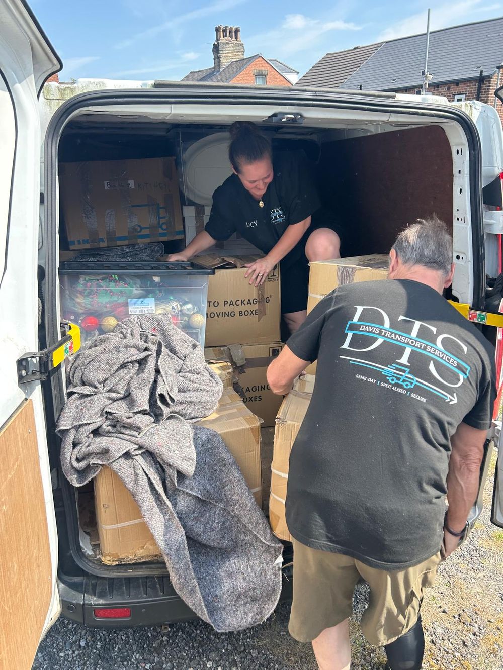 Davis Transport Services team loading boxes into the van during a house move