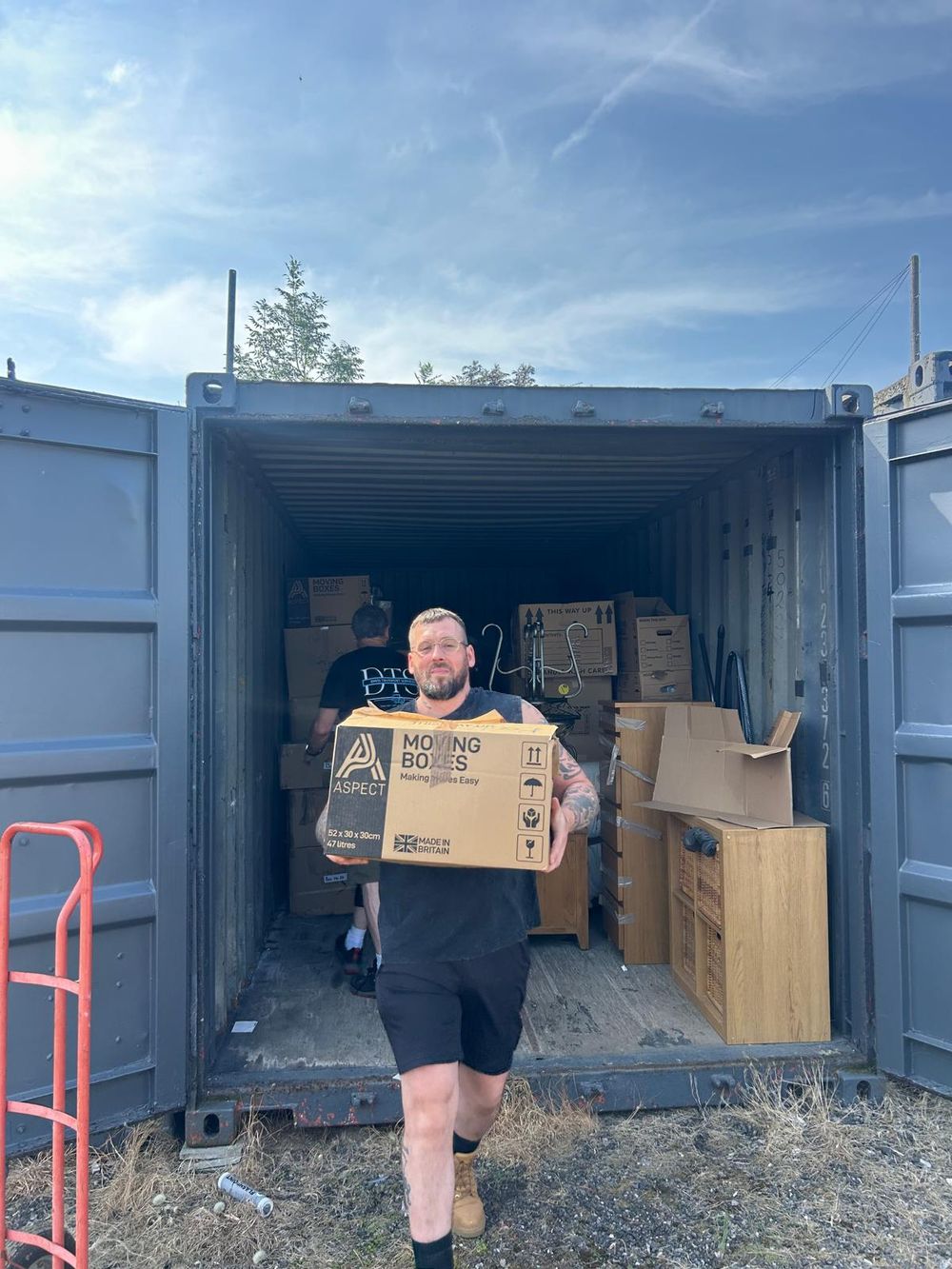 Davis Transport Services team member handling a storage container collection